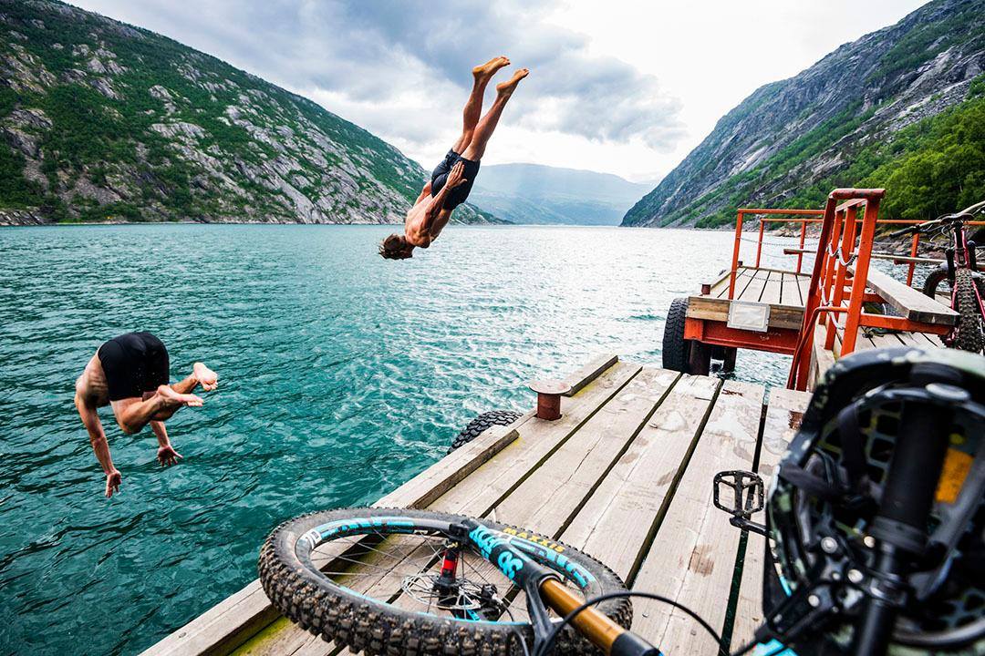 A wonderfully frigid finish. Micke Ekenstam and Carston Oliver cool off in Rombak Fjord after riding single track from Sweden to Norway.