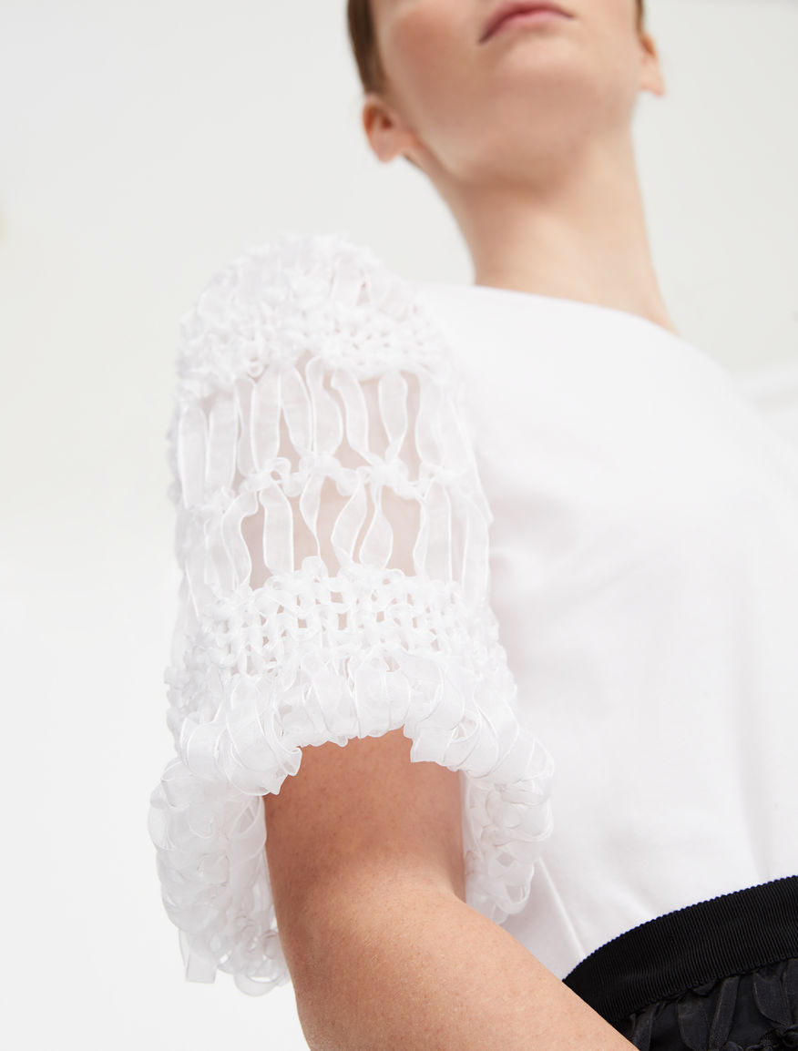 Tops and shirts with puffed or flared sleeves, braided elements and ruffles define the topwear selection of OnSet, the Signature Collection created in collaboration with Gabriella Pescucci for Spring Summer '20.