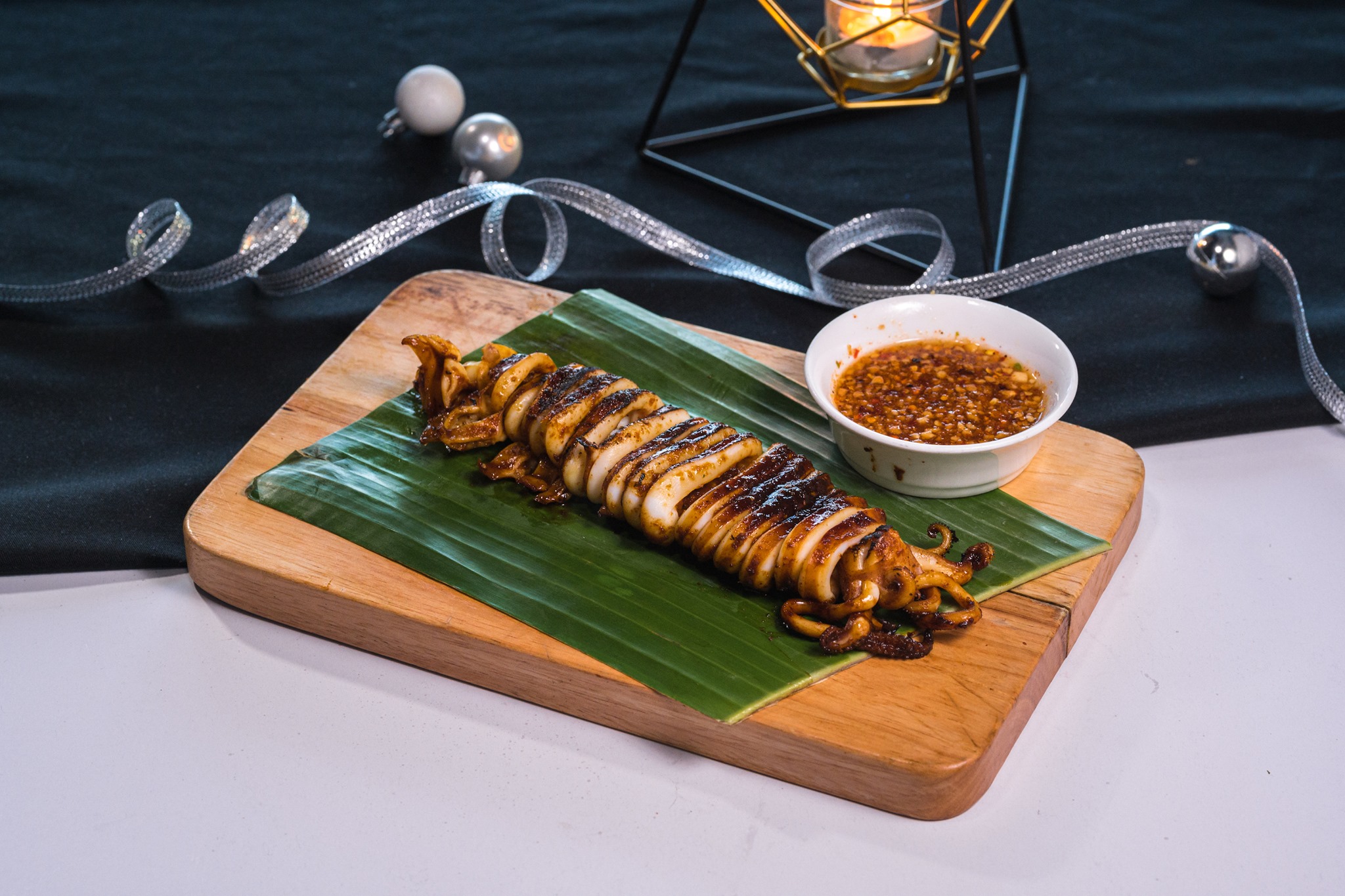 Chargrilled Squid with Spicy Tangy Sauce - this chargrilled giant squid will “WOW” you at first glance. Served with traditional seafood sauce topped with grounded peanuts. Perfect for sharing!  #GreyhoundCafeHK #GreyhoundCafe #Thaifood #泰菜 