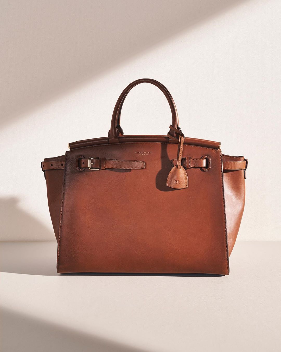 A new icon embodying the signatures of #RalphLauren design. Each RL50 Handbag is entirely handcrafted in an artisanal Italian studio — from its elegant, effortlessly functional silhouette to hand-painted edges and stitch details subtly referencing the construction of equestrian bridle straps. Discover #TheRL50 collection at