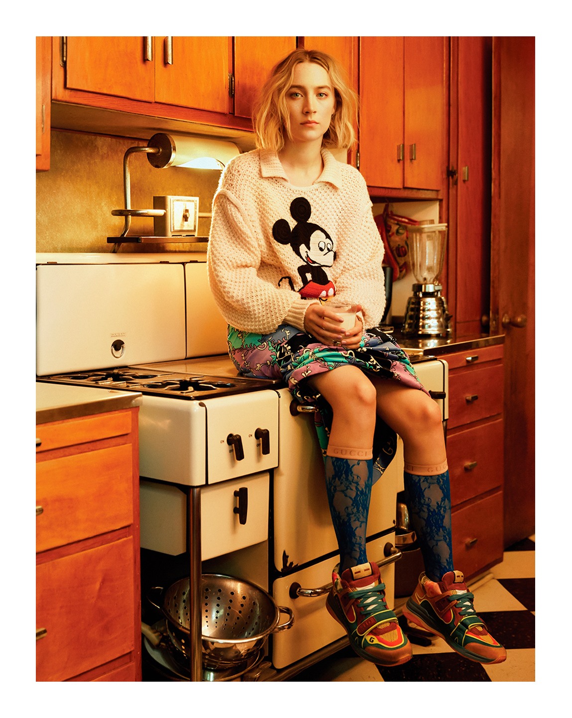 Vogue Korea’s January issue features Saoirse Ronan wearing a selection of Gucci pieces including a wool sweater from the Disney X Gucci collection and the Gucci Ultrapace sneakers. © Disney