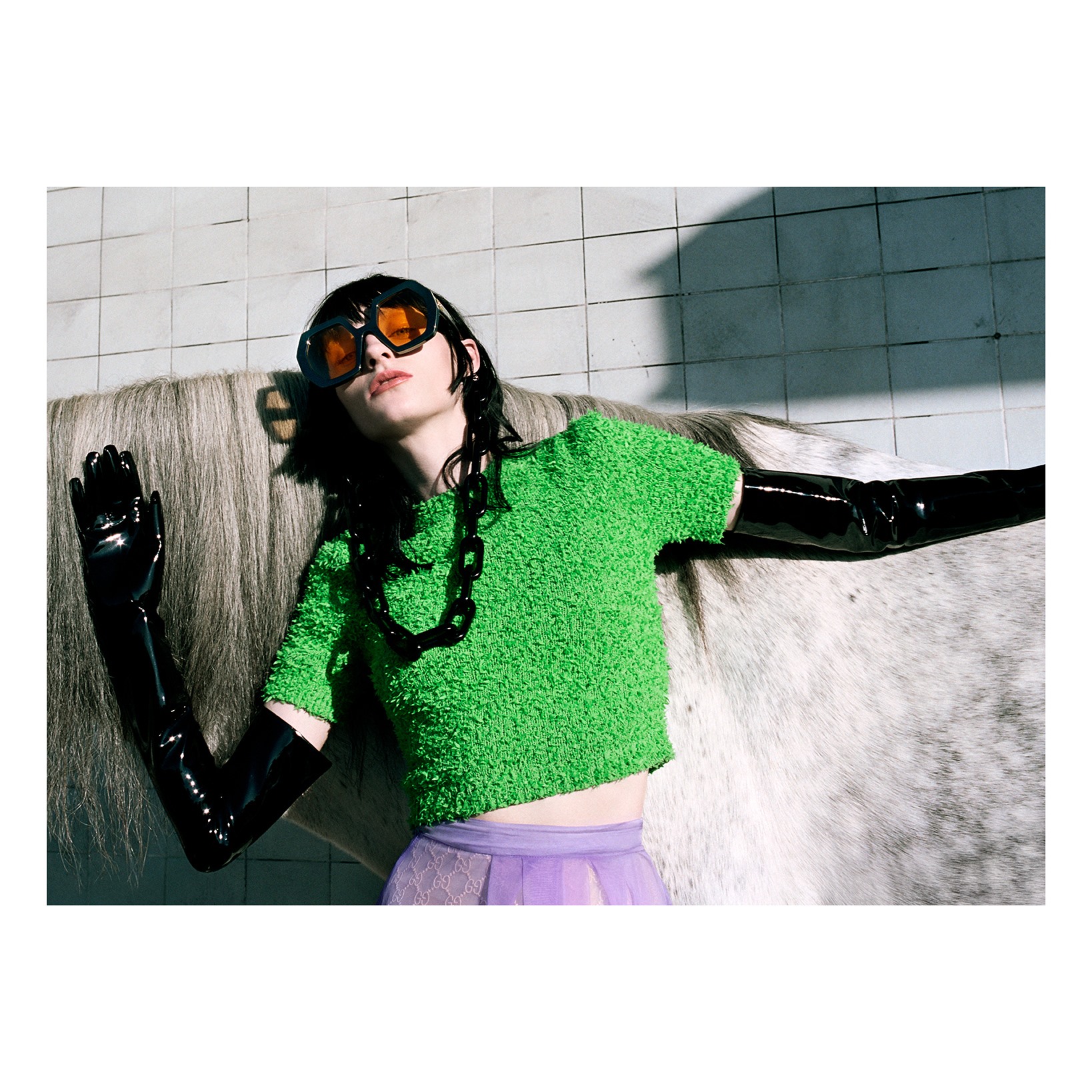 Gucci Eyewear sunglasses accessorized with a resin glasses chain featuring oversize links appear in an image from the Gucci Spring Summer 2020 campaign Of Course A Horse. Discover more on.gucci.com/GucciWomenEyewear_. 