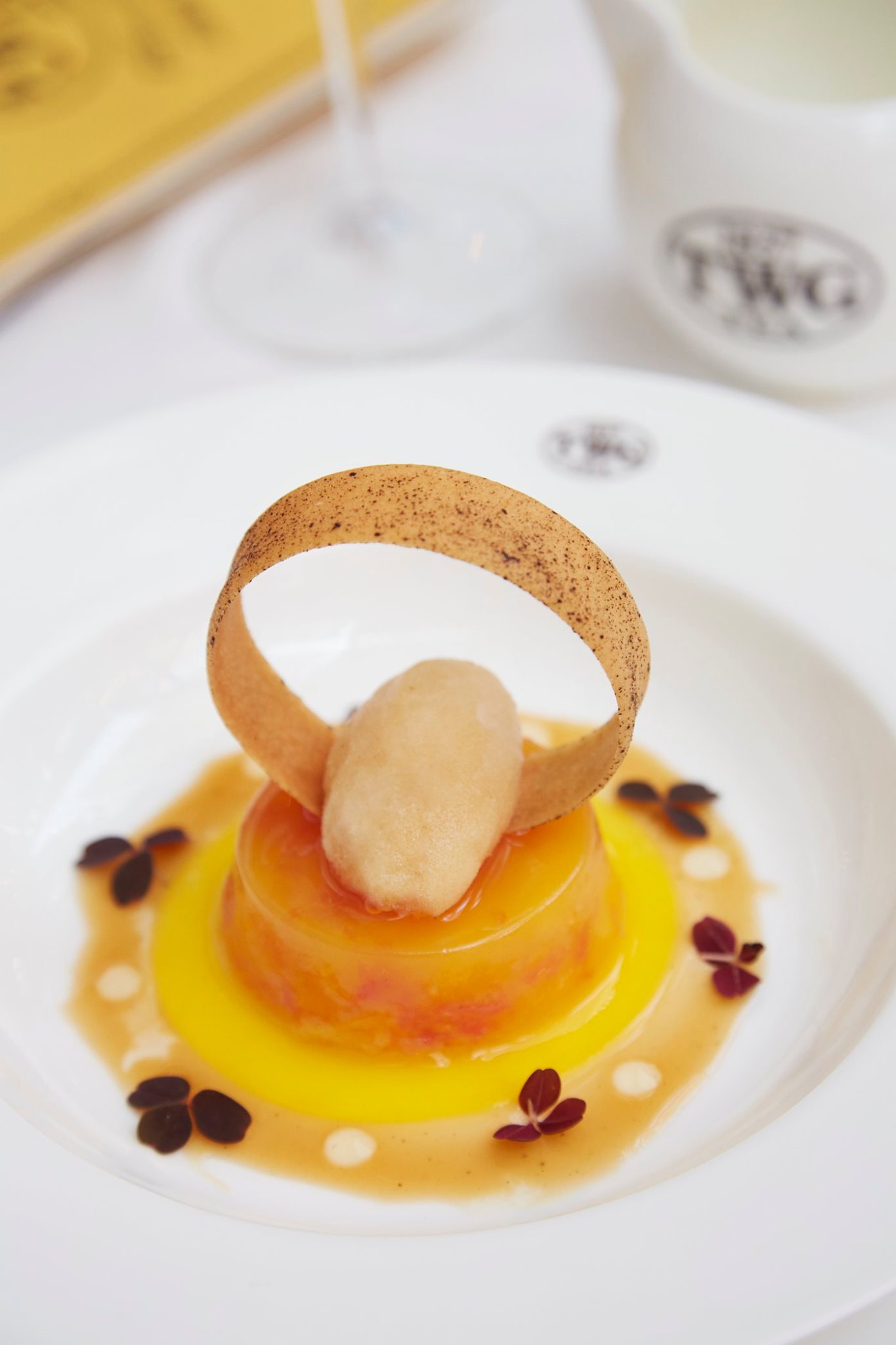 Dive into TWG Tea grapefruit and orange gelée served with a French Earl Grey infused nage and a scoop of French Earl Grey sorbet, topped with an almond tuile. Available on this week's Set Menu at all TWG Tea Salons in Singapore.