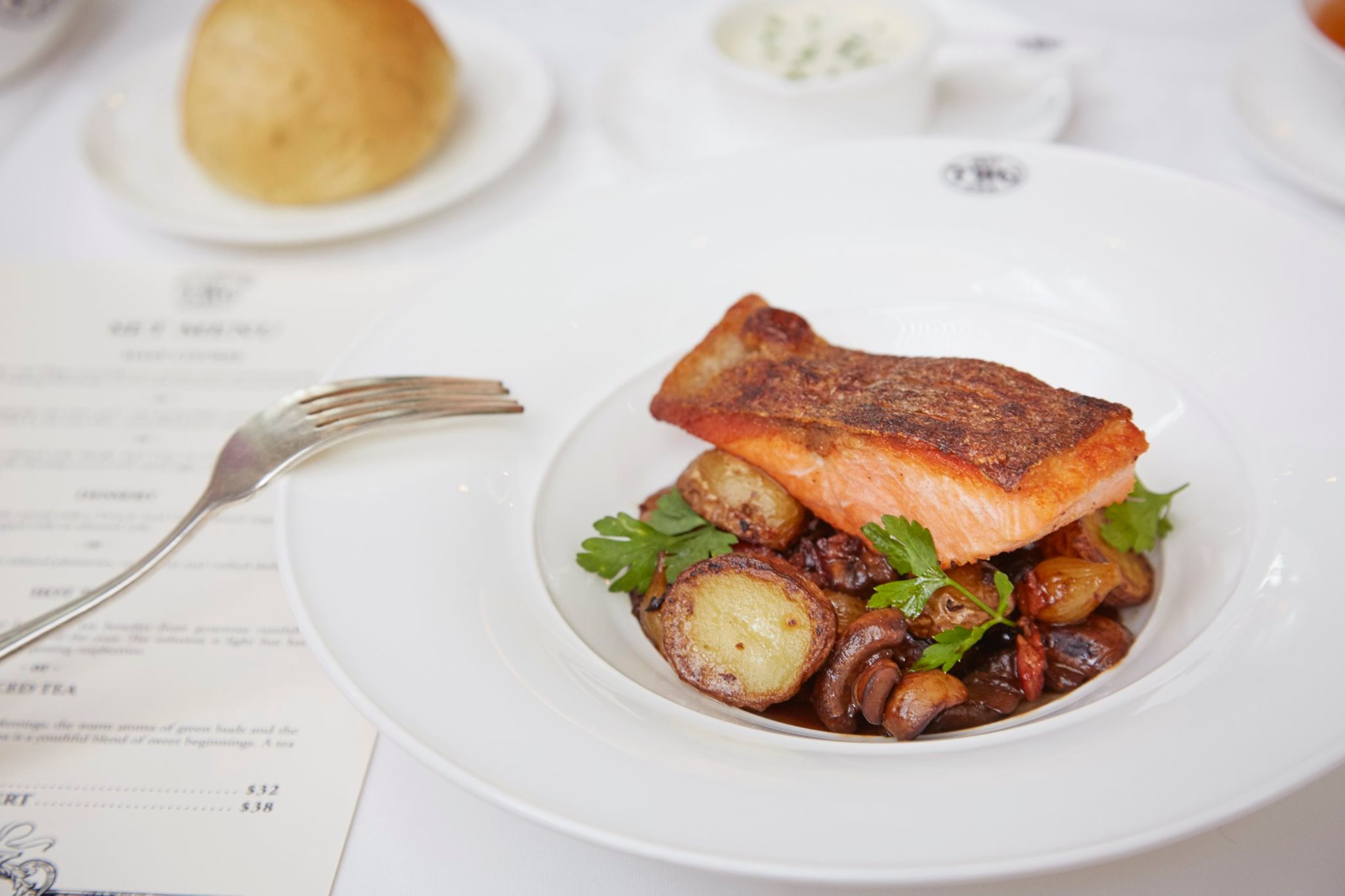 Salmon in a Burgundy red wine sauce and horseradish cream, accompanied by sautéed potatoes infused with Lu An Gua Pian, caramlised pearl onions, veal bacon and mushrooms on this week's Set Menu. Available at all TWG Salons in Singapore.
