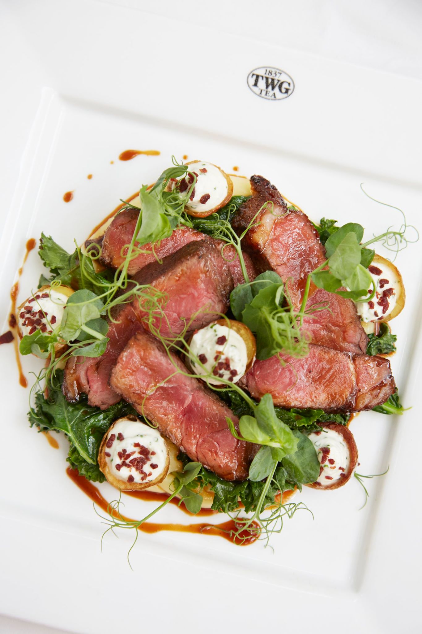 Grain-fed Angus striploin steak with a Black Pagoda Tea infused glaze, accompanied by potato skins and garlic whipped cream, served with sautéed kale and potato mash. Available at all TWG Tea Salons in Singapore on this week's set menu.