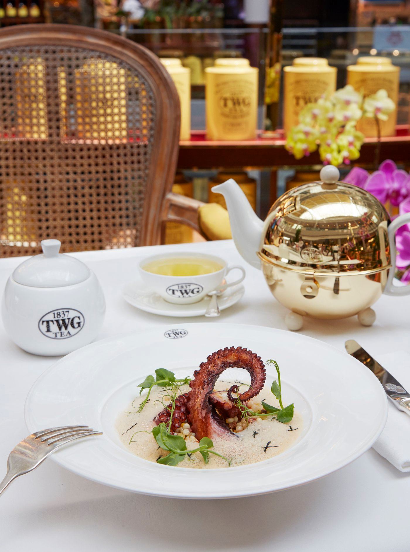 Indulge in TWG Tea seared Spanish octopus served with a langoustine emulsion sprinkled with African Ball Tea leaves, accompanied by a pearl couscous ragout with diced wagyu chorizo and king oyster mushrooms at any TWG Tea Salons in Singapore. 