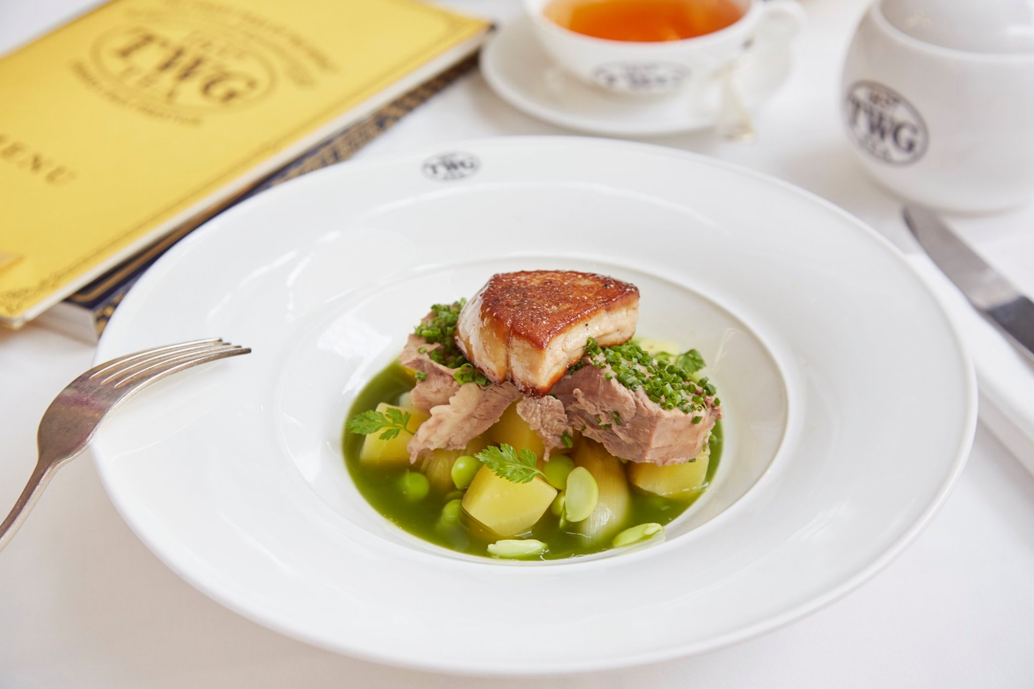 Traditional French beef brisket clear stew with seared foie gras accompanied by tender winter vegetables, served with a Matcha infused kale broth. 