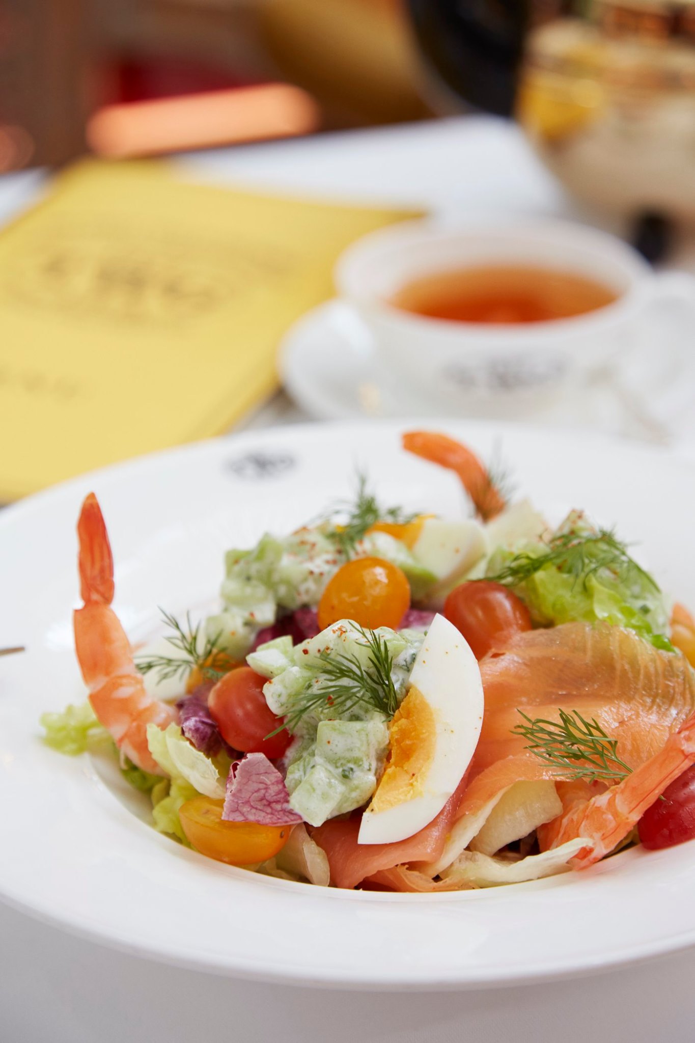 Scottish smoked salmon and poached shrimp accompanied by a Romaine lettuce and fennel salad elegantly garnished with yoghurt marinated cucumbers, avocado, cherry tomatoes and a hard-boiled egg served with a Tokyo-Singapore Tea infused dressing.