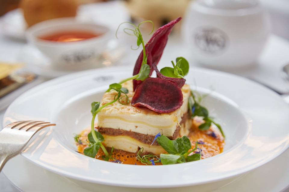 Rendang beef cheek lasagna served with a Jasmine Pearl Tea infused tamarind tomato sauce, accompanied by purple sweet potato chips and pea tendrils. 