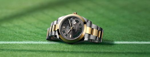 Precision and elegance on Centre Court. The #Rolex Datejust 41 in a yellow Rolesor version – a combination of Oystersteel and 18ct yellow gold – featuring a slate dial with black and green Roman numerals. #Datejust #Perpetual