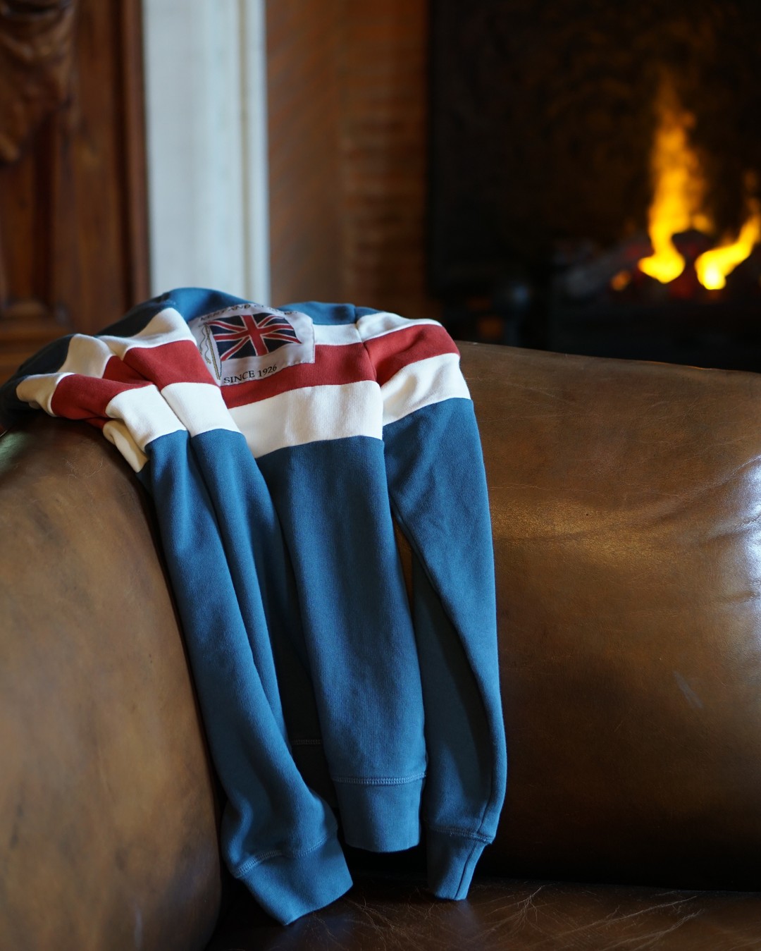 Our classic fit sweatshirt knitted with two thick racing stripes in ecru and red on a vintage blue ground, and finished with our archive woven Union Flag patch.