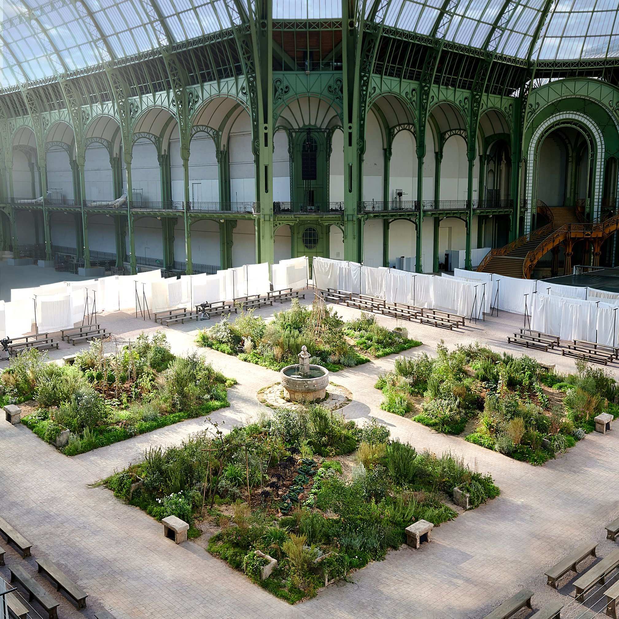 The nave of the Grand Palais has metamorphosed into a cloister garden for Virginie Viard’s CHANEL Spring-Summer 2020 Haute Couture show in Paris. The setting evokes one of the key places in Gabrielle Chanel’s childhood — the ancient Cistercian Abbey of Aubazine.
