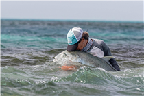 Millie Paini shares a tender moment with her fifth Giant Trevally of the day in the Seychelles.