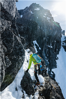 Colin Haley navigates mixed terrain during an early season ascent of the North Ridge of Mount Stuart in the Alpine Lakes Wilderness, Washington. 