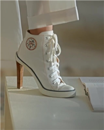 Classic Ralph Lauren style, newly considered for Spring 2020. The collection's ivory trench coat is crafted in basket-weave Italian linen, treated with a transparent lacquer for a subtle luster. And the high-top sneaker, reimagined with a stacked pump heel, is stitched from washed cotton canvas with an embroidered logo patch. Discover more from #RLCollection Spring 2020:
