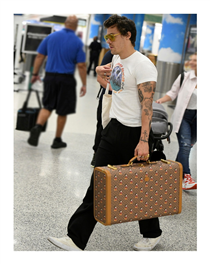 Harry Styles—who stars in the Gucci Mémoire d’une Odeur campaign seen on Gucci Beauty—spotted in Miami with a Gucci Cruise 2020 mini Disney X Gucci GG suitcase with all-over Mickey Mouse print, Gucci Eyewear acetate sunglasses and Gucci Jewelry rings.