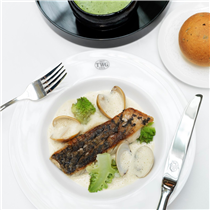 Pan-seared barramundi fillet accompanied by a truffled Jerusalum artichoke puree and romanesco cauliflower, served with claims in a white wine and Sencha Prestige infused clam sauce. 