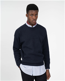 Navy lambswool intarsia knit worn with classic rose embroidered oxford shirt and navy wool trousers. 